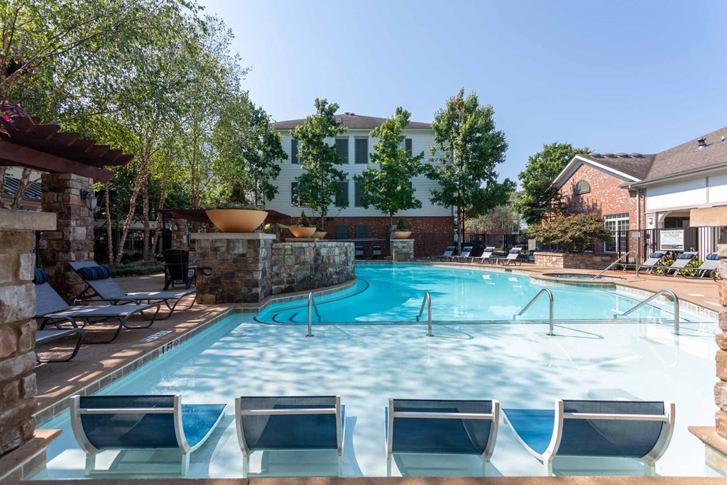 A pool with lounge chairs