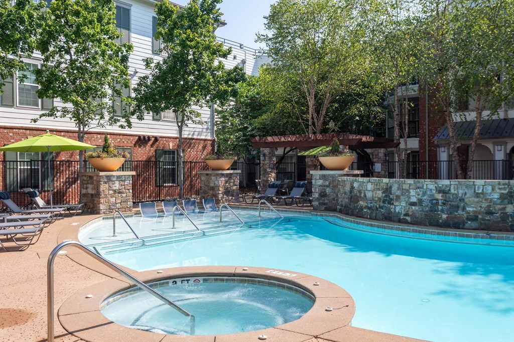 A pool with a hot tub in the middle of it.