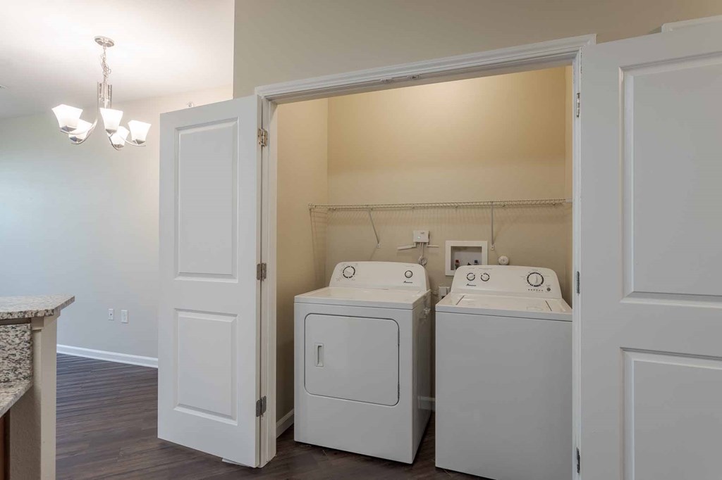 A laundry room with a washer and dryer in it.