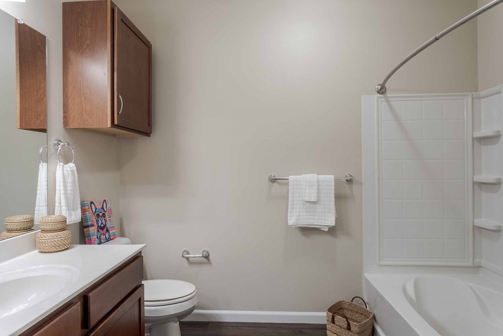 A bathroom with a toilet, sink, and bathtub.