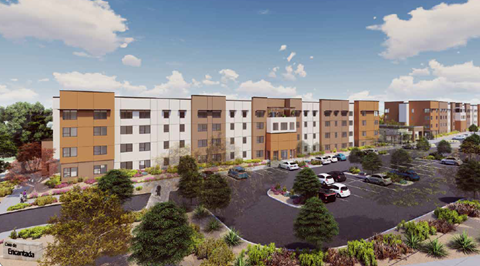 A large building complex with a parking lot in front.