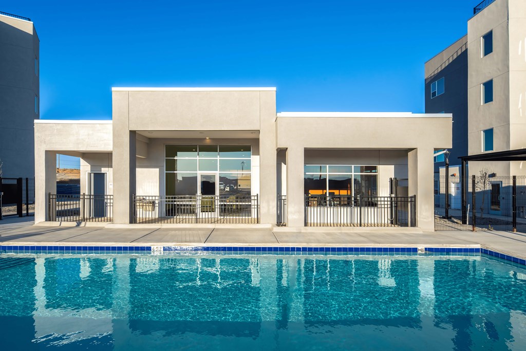 A modern building with a pool in front.