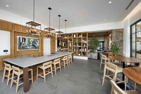 A modern dining room with a long table and chairs.