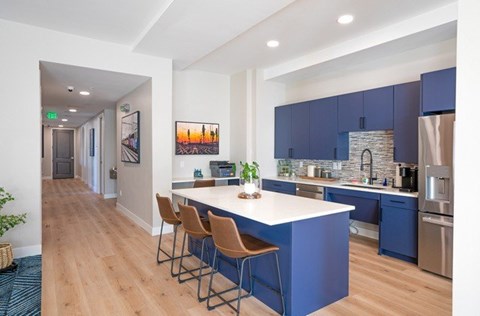A kitchen with blue cabinets and a white island.