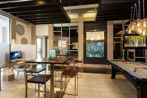 a living room with a pool table and a tv
