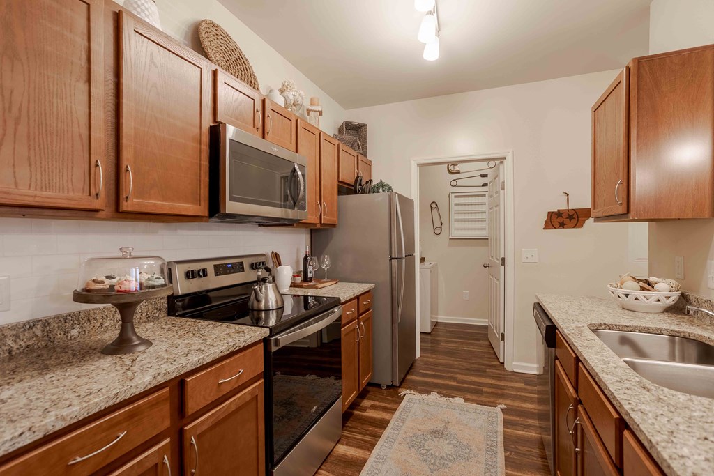 a kitchen with stainless steel appliances and granite counter tops
