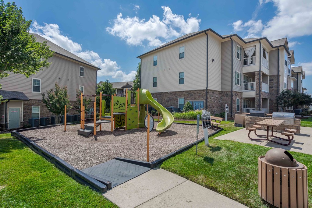 our apartments have a playground with a slide and picnic table