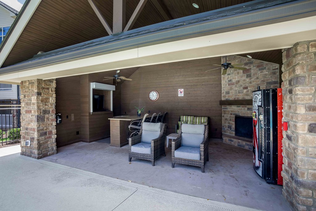 a covered patio with chairs and a fire hydrant
