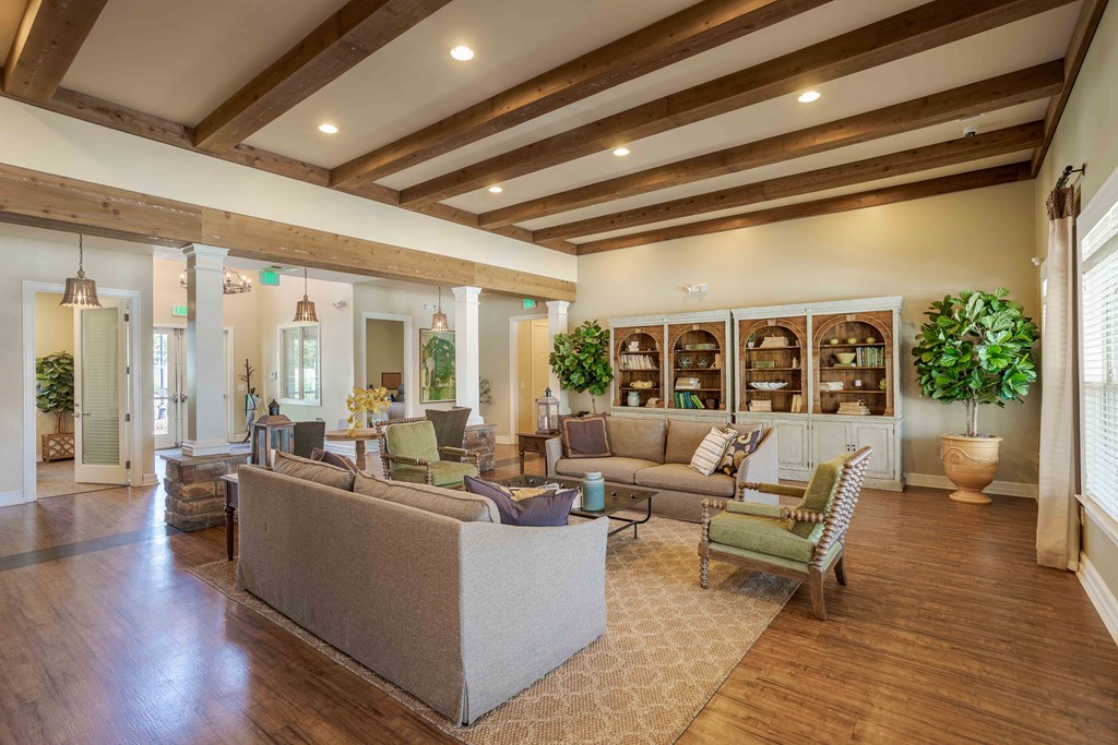 a large living room with couches and chairs