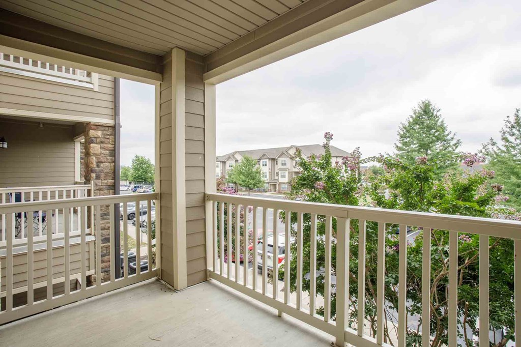 A balcony with a view of a residential area.