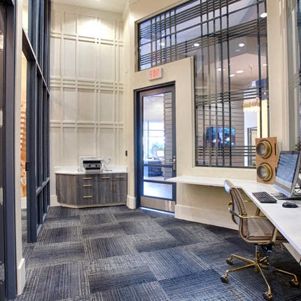 a large office with a desk and a door