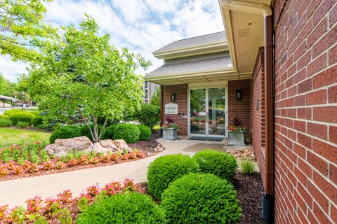 a walkway in front of a brick building