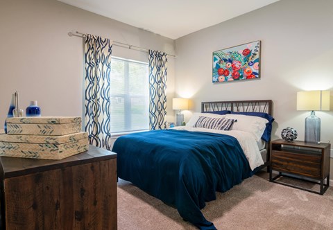 a bedroom with a bed and a dresser and a window