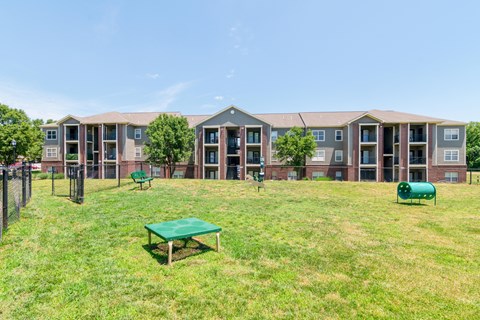 an apartment building with a grassy pet area