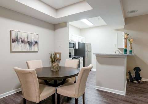 a dining room with a table and chairs and a kitchen