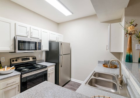 a kitchen with stainless steel appliances and white cabinets