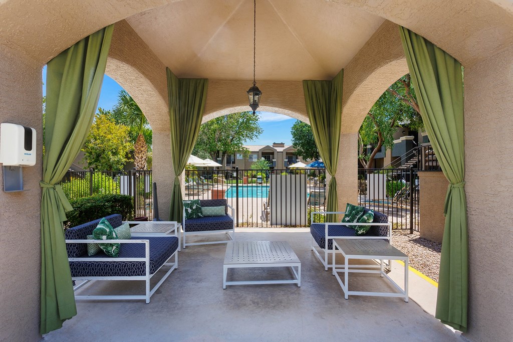a patio with couches and chairs and a pool