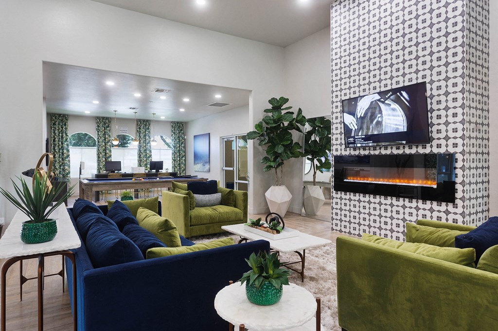 a living room with couches and chairs and a fireplace