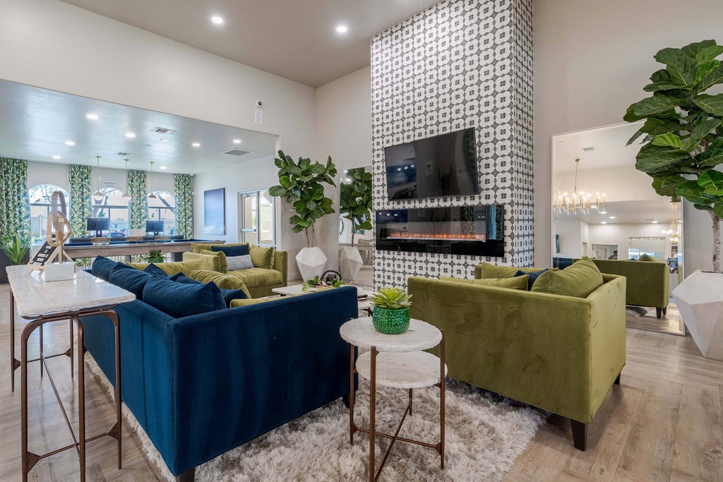 Clubhouse with couches and chairs and a fireplace