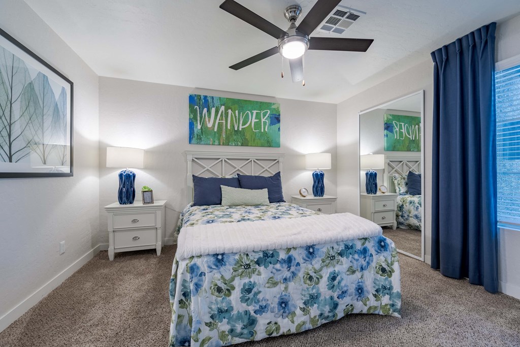 a bedroom with a bed and a ceiling fan