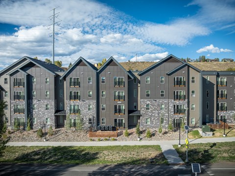 A row of modern houses with grey exteriors and stone accents.