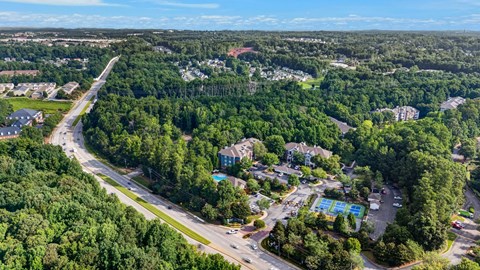 A bird's eye view of a residential area with a road running through it.