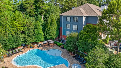 A blue house with a pool in the backyard.