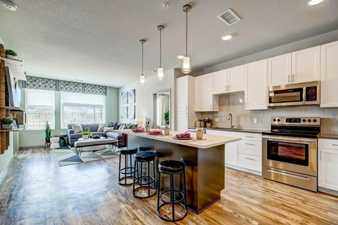 A kitchen with a white oven and white cabinets.