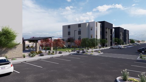 A modern building with a parking lot in front of it.