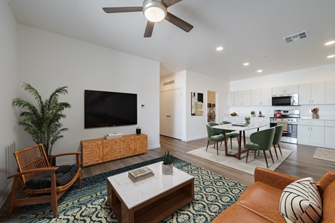 A living room with a brown chair and a white coffee table.