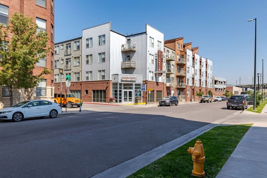 a city street with buildings and a yellow fire hydrant