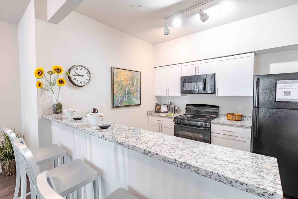 A kitchen with high top seating.