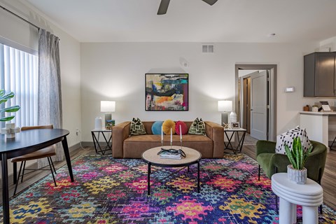 a living room with a vibrant carpet at furniture