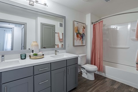 a bathroom with a large mirror and a toilet and a shower