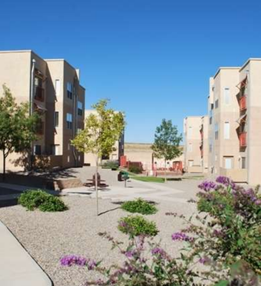 A sunny day in a courtyard surrounded by residential buildings.