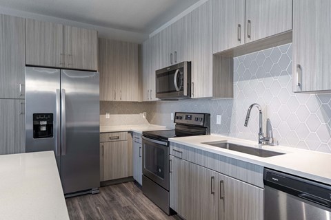 a kitchen with stainless steel appliances and a sink