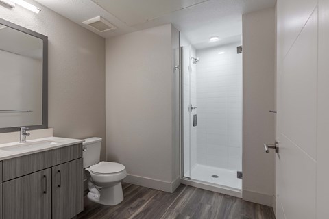 a bathroom with a shower and a toilet and a sink