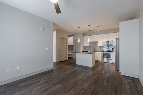 a kitchen with white cabinets and stainless steel appliances and a wood floor