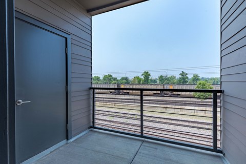 the view from the balcony of a train on the tracks