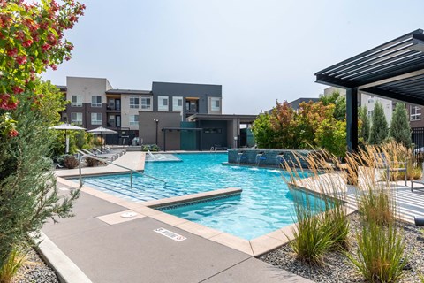 a swimming pool with a building in the background