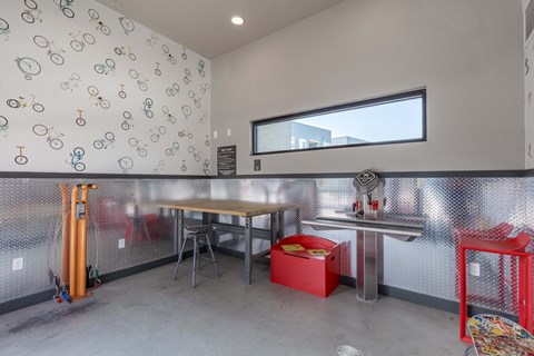 a break room with a table and chairs and a window