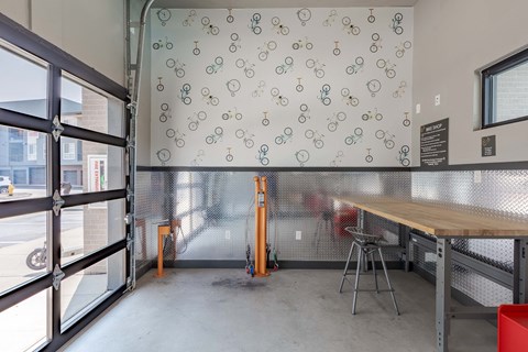 a dining room with a table and chairs and a wall with bikes on it