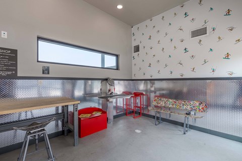 a room with a table and chairs and a wall with kites on it