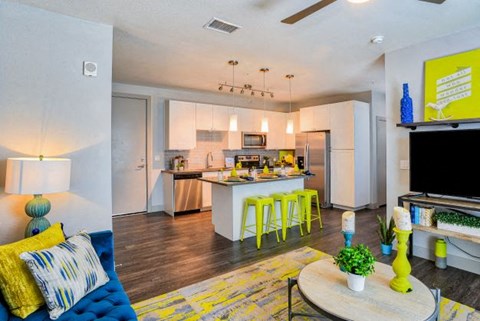 a living room with a kitchen and a table