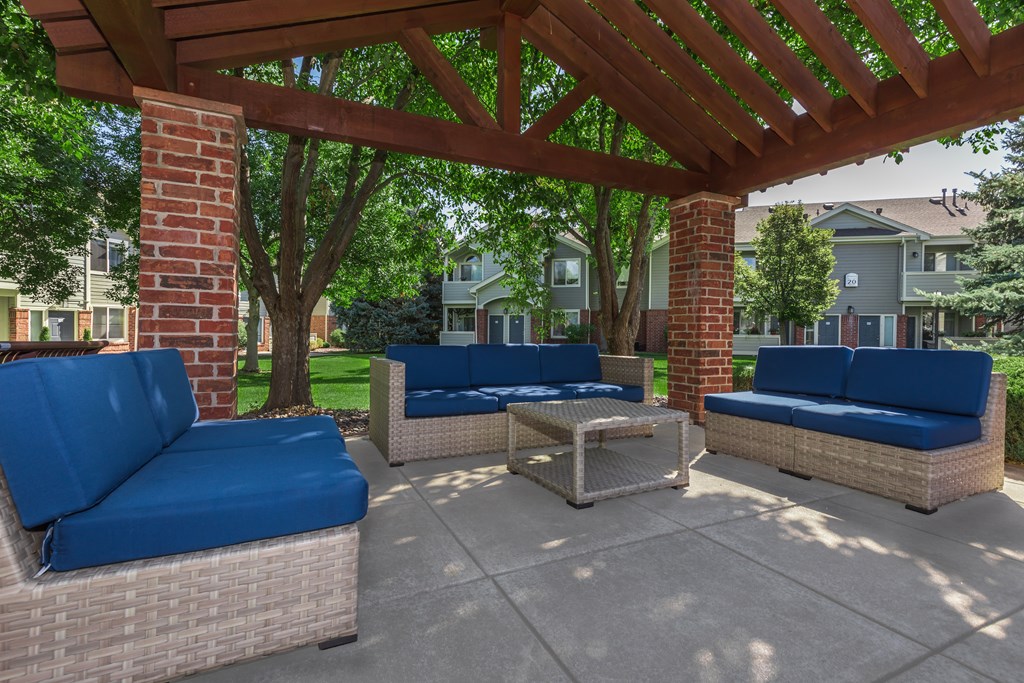 Outdoor lounge area and a wooden pergola.