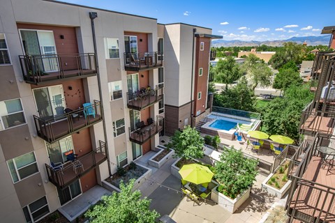 Apartment complex with a pool and patio area.