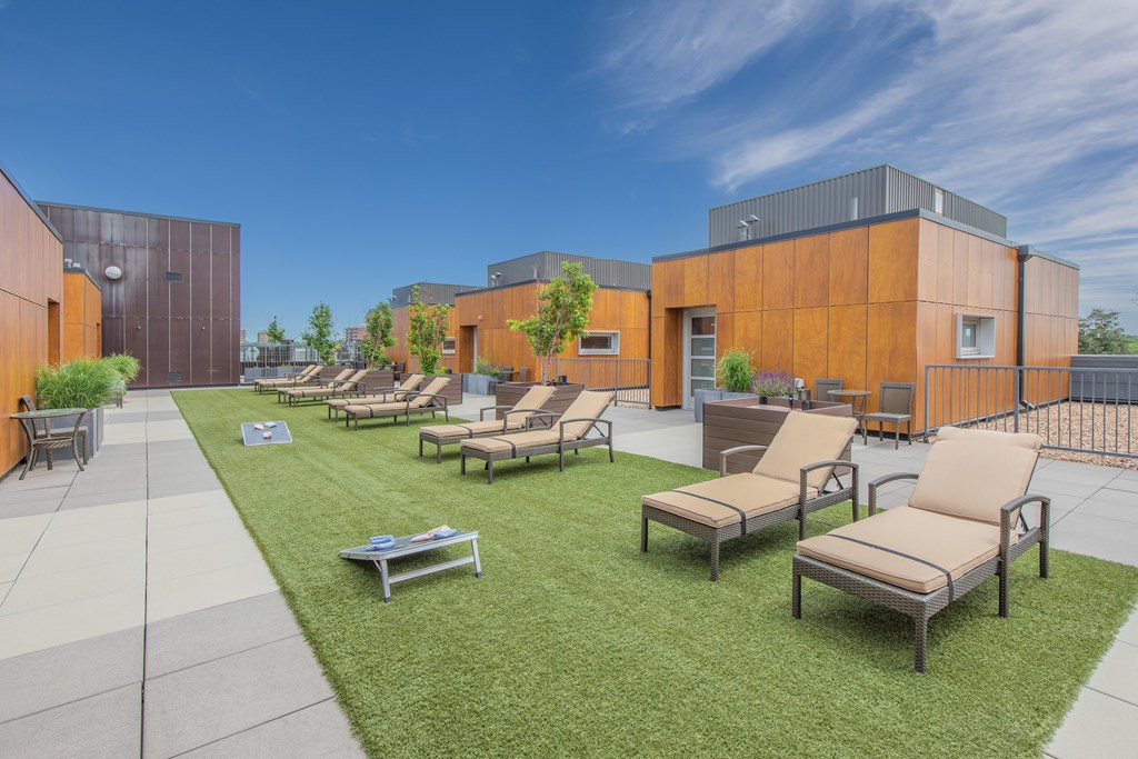 Rooftop deck with lounge chairs and lawn games