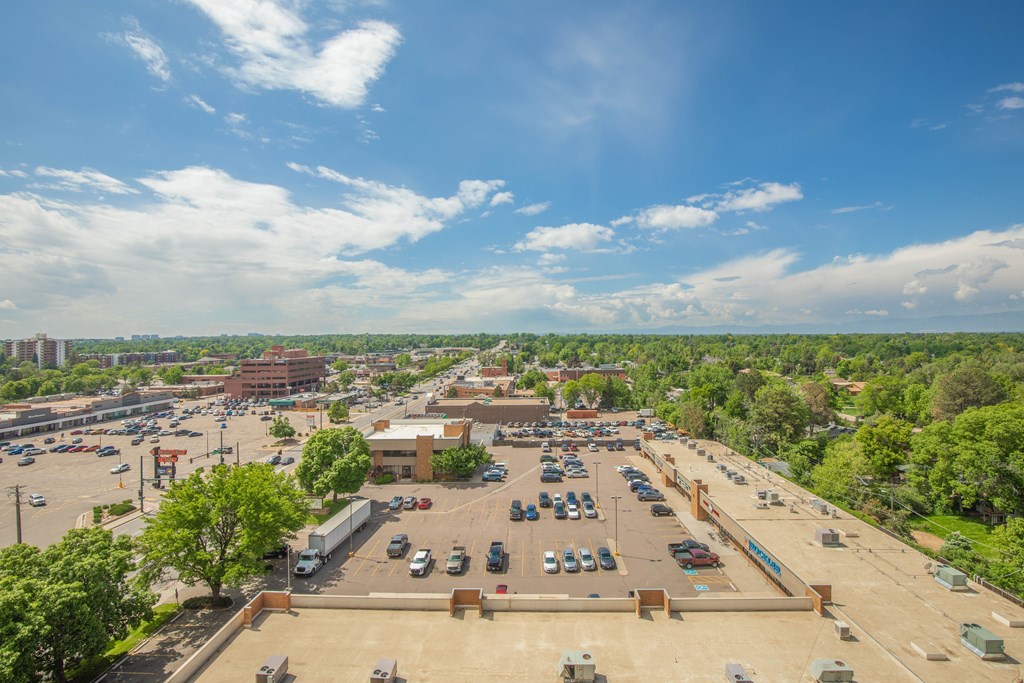 View of parking lot and trees from rooftop deck