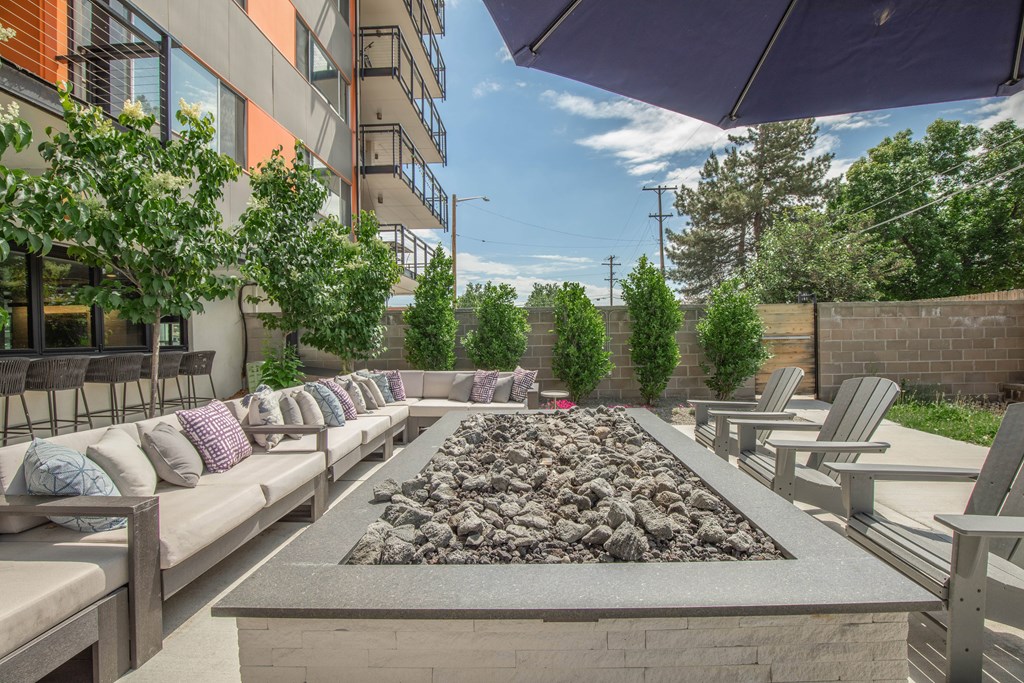 Outdoor lounge with a stone fireplace