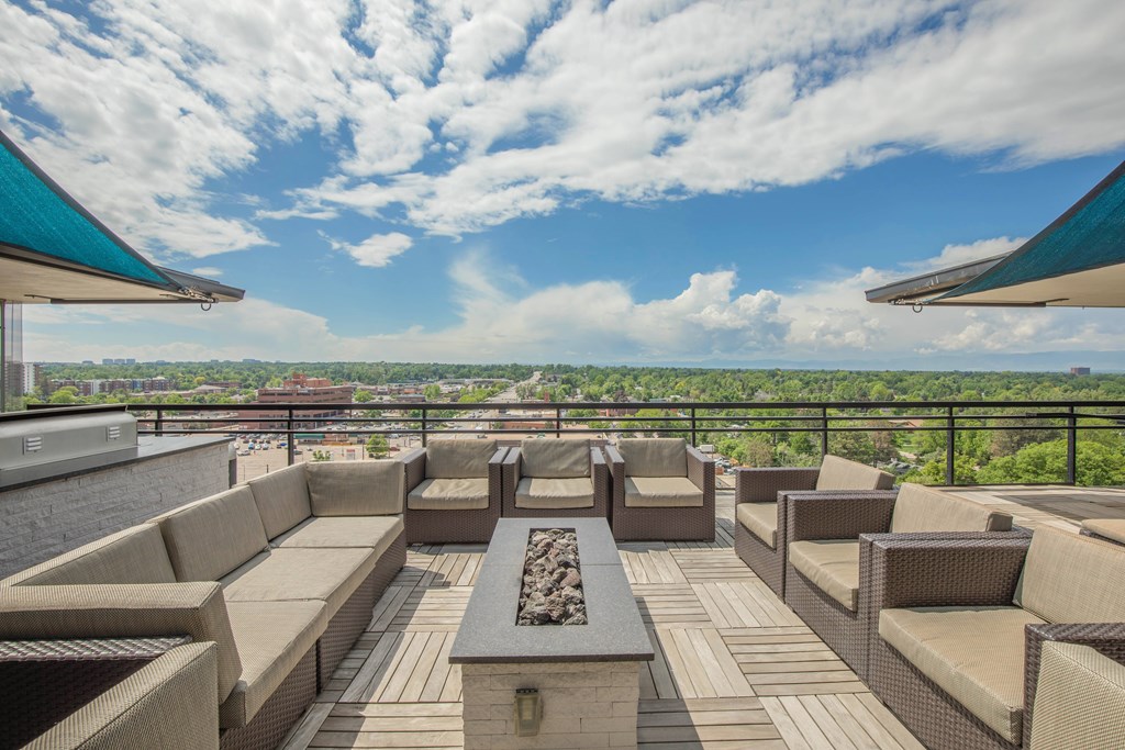 A patio with furniture and a view of the city.